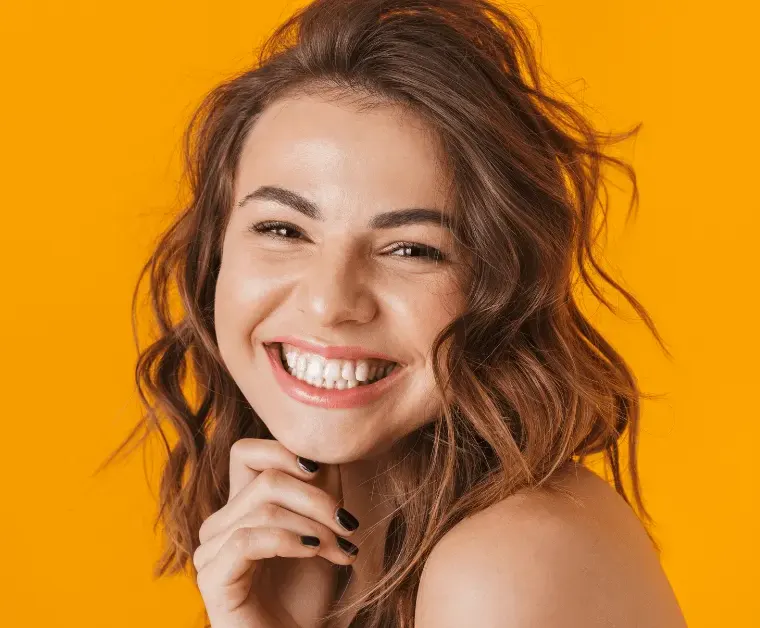 Confident bright smile after professional teeth whitening treatment.